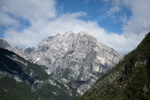 Preview: Rocky mountain peak seen from the middle of two mountain forests, Italy