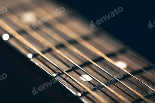 Preview: Part of an acoustic guitar, guitar fretboard on a black background.