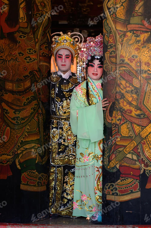 Preview: Portrait of male and female opera performers at the entrance to a sacred shrine or temple