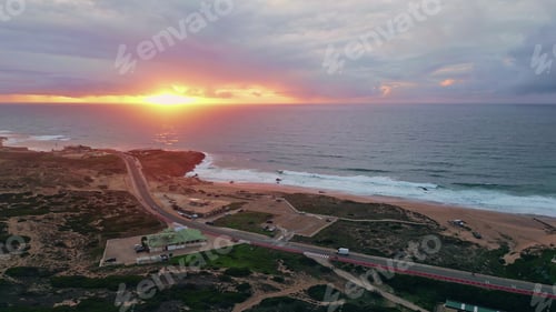 Preview: Sunset bathing coastal landscape in golden light. Picturesque ocean waves glow