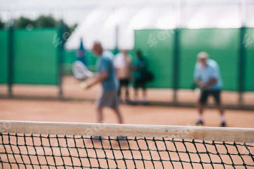 Preview: selective focus of net and tennis players playing tennis on court