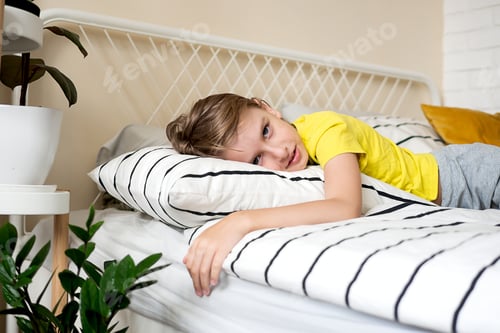 Preview: Child Relaxing on Bed at Home in Daytime