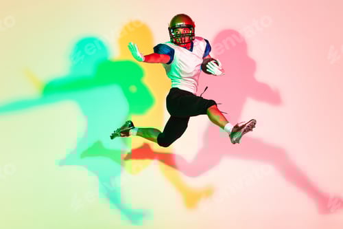 Preview: American football player isolated on gradient studio background in neon light with shadows
