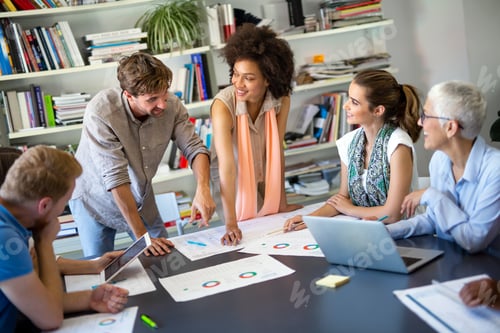 Preview: Group of happy business people discussing and working together during a meeting in office