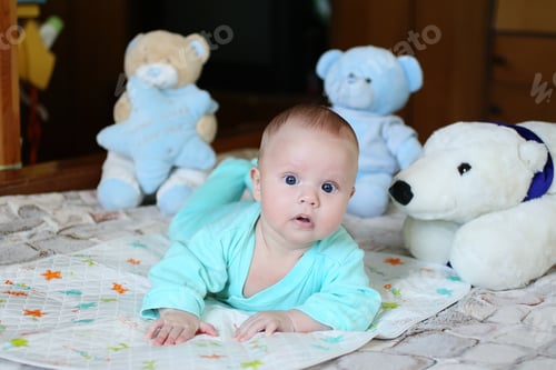 Preview: Little infant looking at the camera.