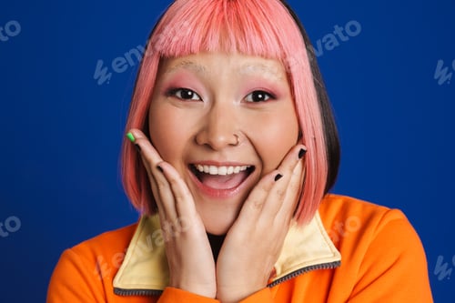 Preview: Asian girl with pink hair and piercing laughing while looking at camera