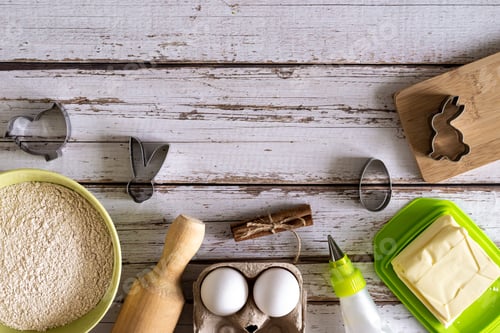 Preview: Top view on wooden background ingredients for making cookies for easter