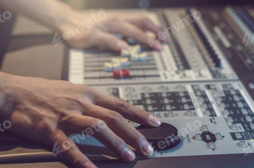Preview: Hand adjusting audio mixer in dark studio, music instrument concept