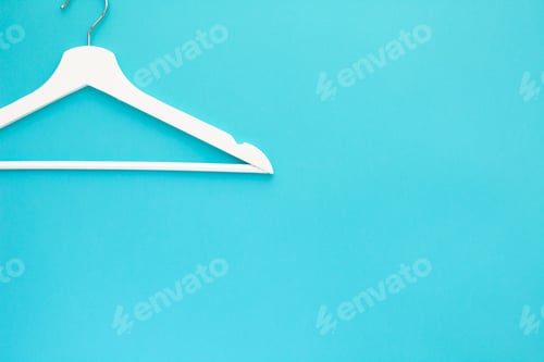 Preview: White wooden hangers on blue background