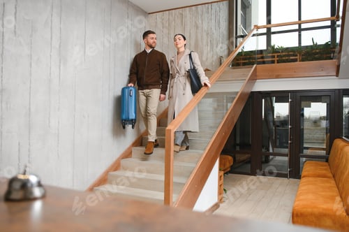 Preview: Young couple near reception desk in hotel. Young couple leaving hotel