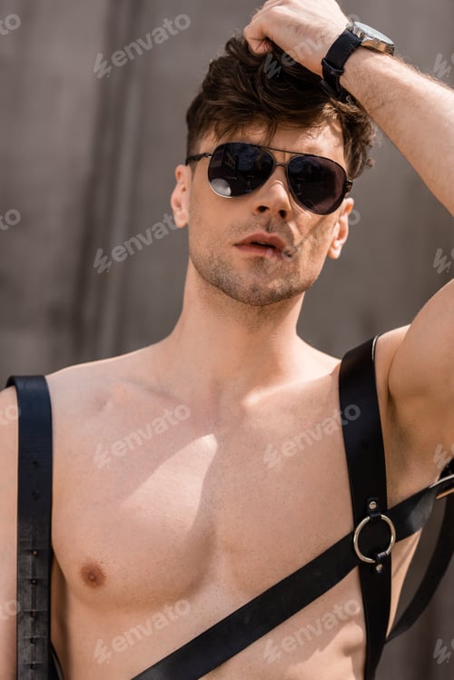 Preview: stylish sexy man in black sunglasses and sword belt