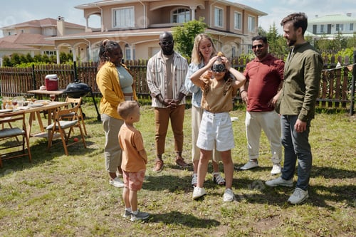 Preview: Young woman blindfolding little daughter while playing hide and seek