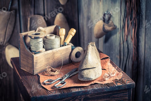 Preview: Small cobbler workplace with tools, shoes and laces