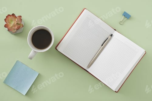 Preview: Top view of Office background with open notebook and ballpoint pen on green with sticky memo pad
