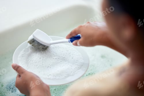 Preview: Cleaning kitchen, soap water and hands of woman cleaner to clean plate with a brush for hygiene. Ma