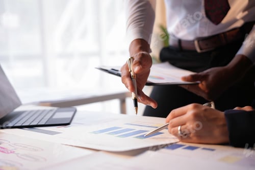 Preview: Business people analyzing financial chart together in office meeting