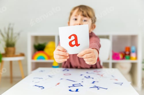 Preview: The child learns English letters. Selective focus.