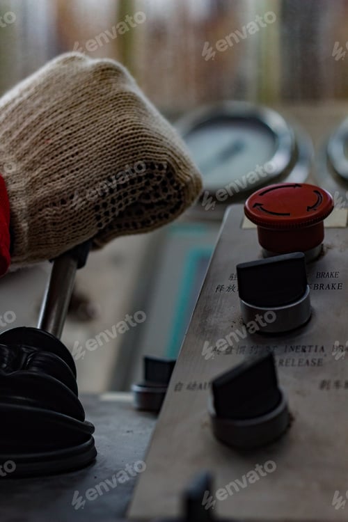 Preview: Vertical closeup of a construction worker operating an equipment in an industrial spot