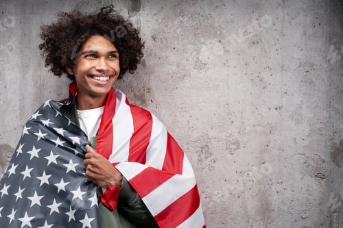 Preview: Happy African American man holding american flag looking away isolated on gray background