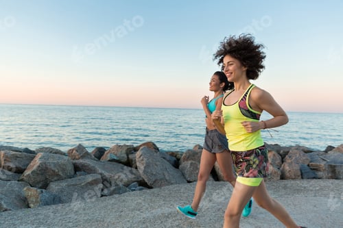 Preview: Happy smiling fitness women jogging together