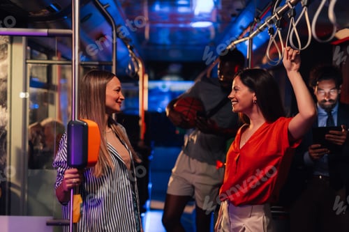 Preview: Two young women talking on a moving bus at night