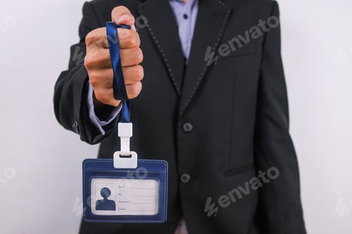 Preview: Close-Up Of Businessman In Black Suit Gripping Blue Lanyard With A Dangling ID Badge Holder