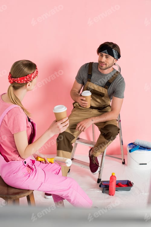 Preview: woman resting on chair with paper cup of coffee and boyfriend sitting on ladder with coffee cup in