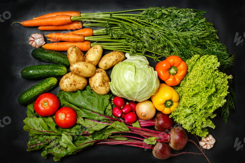 Preview: Top view of fresh assorted vegetables on dark black background