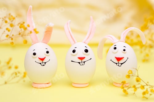 Preview: Easter bunnies made of eggs with funny faces painted on them.Happy Easter concept.