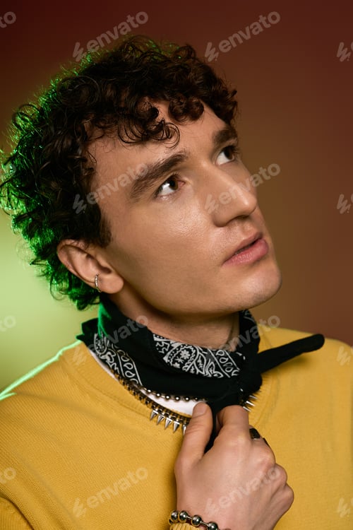 Preview: Handsome man showcasing stylish attire with distinctive accessories and captivating expression