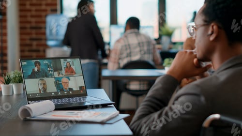Preview: African american man talking to colleagues on videocall meeting