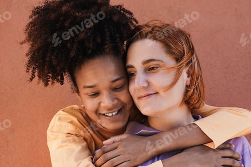 Preview: Multiracial lesbian couple having tender moment outdoor