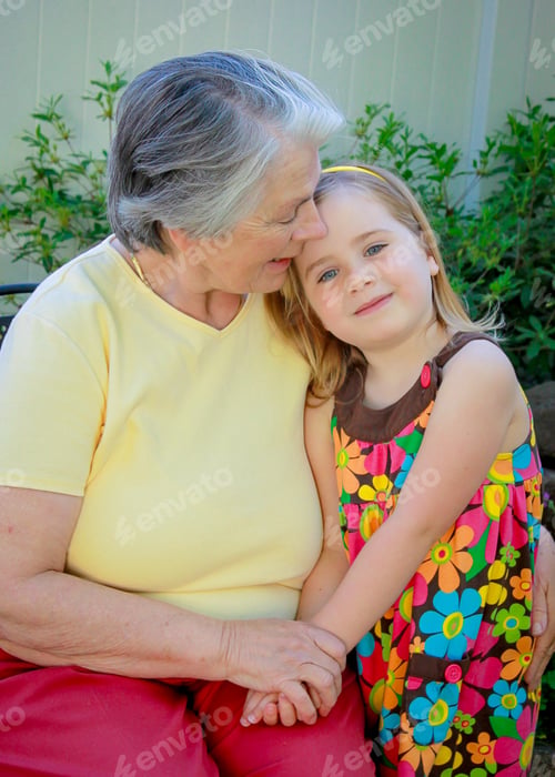 Preview: Grandmother talking to her grandchild and giving her comfort while hugging her