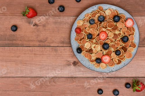 Preview: Tiny Pancakes with Fresh Berries on Wood Background