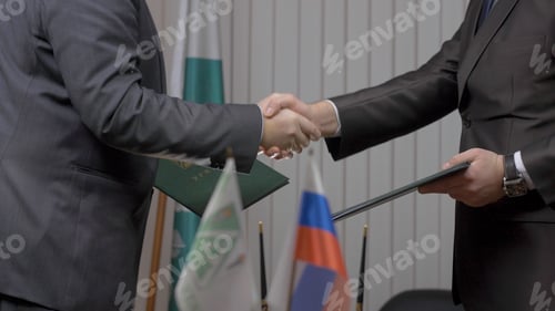 Preview: Two businessman with made a deal. Two businessmen shaking hands indicating successfully made deal