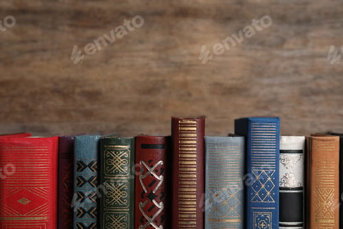 Preview: Stack of hardcover books on wooden background. Space for text