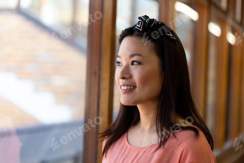 Preview: Portrait of happy asian female teacher in elementary school corridor