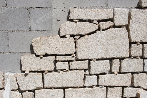 Preview: Detail of Cinder block wall being lined with granite stone slabs