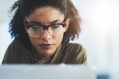 Preview: Shot of a young businesswoman busy working on her laptop in a modern office