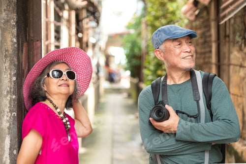 Preview: A happy senior couple strolling along a city's old neighborhood, enjoying travel