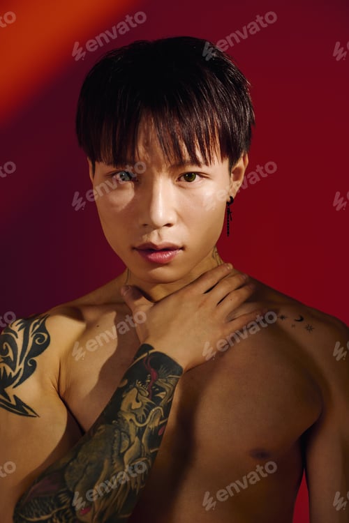 Preview: Stylish young asian man posing confidently with vibrant background and artistic lighting