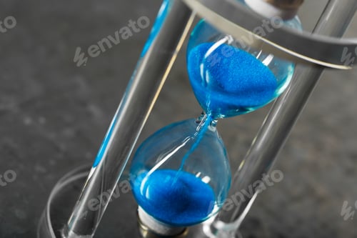 Preview: Time is passing. Blue hourglass close up