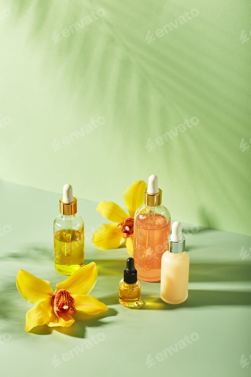Preview: Cosmetic care products in glass bottles with orchid flowers - serums, cream, gel, oils. Concept for