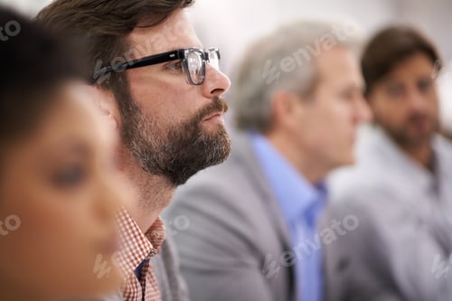 Preview: Focused on the meeting. Shot of a group of diverse businesspeople sitting in a row.