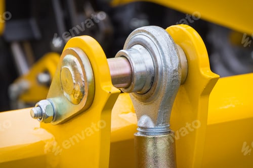 Preview: Screws and bolts as part of yellow agricultural machinery. Technology