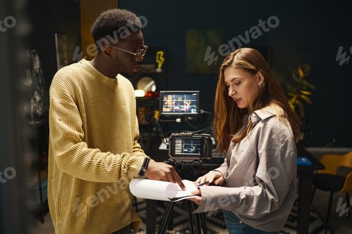 Preview: Colleagues Discussing Script Of Podcast