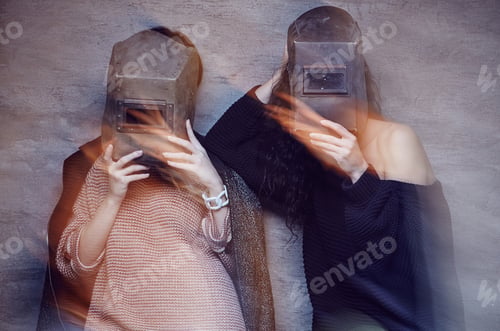 Preview: Two women in a welder masks.