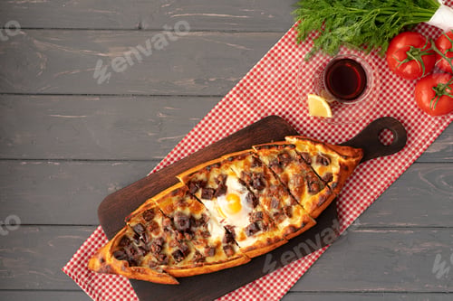 Preview: Turkish stuffed flatbread pide on gray wooden table