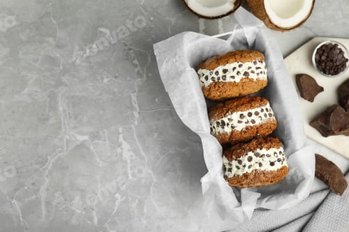 Preview: Sweet delicious ice cream cookie sandwiches on served table, flat lay. Space for text