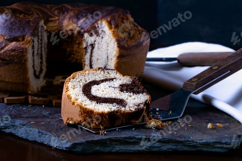Preview: Closeup shot of a piece of delicious homemade marble pound cake on a baking spatula